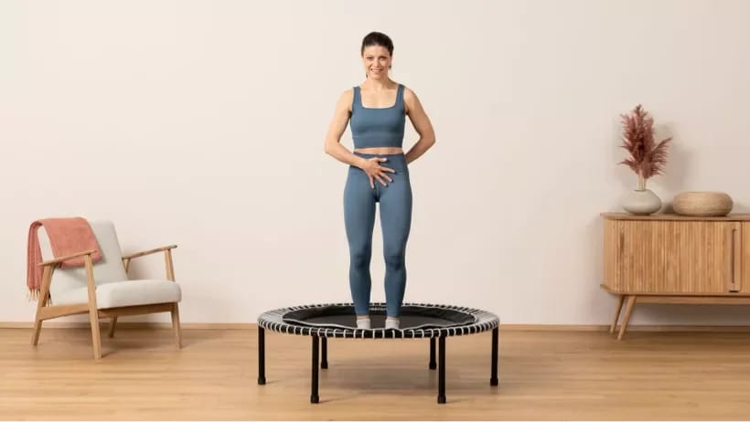 Woman stands on the health rebounder from bellicon and is doing a health bounce.