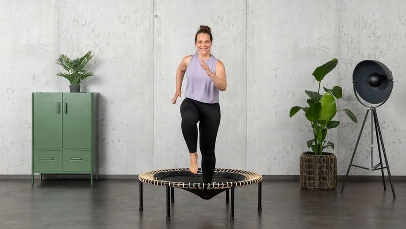Woman doing exercises on a trampoline to lose weight.