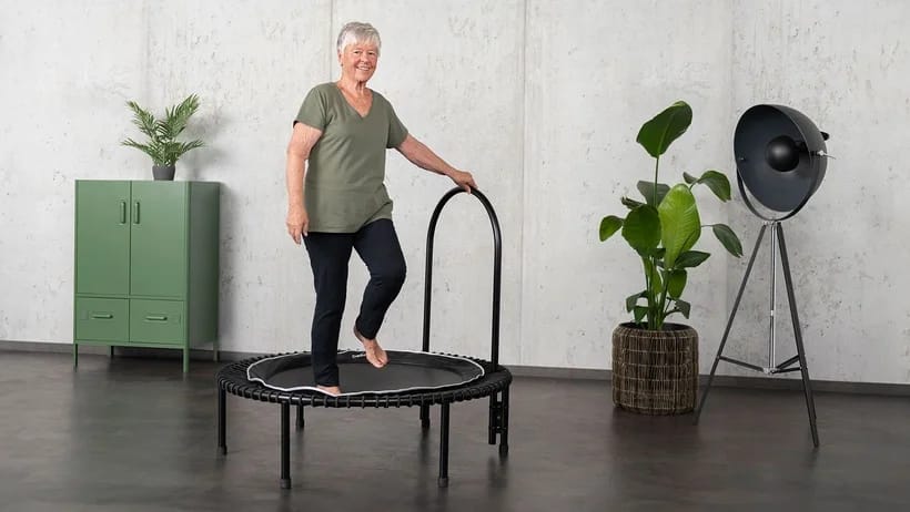 Woman on the bellicon exercising on her coordination.